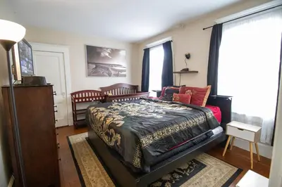 a bedroom with a large bed and a window at Cozy Apartment in Artsy Westville New Haven in New Haven