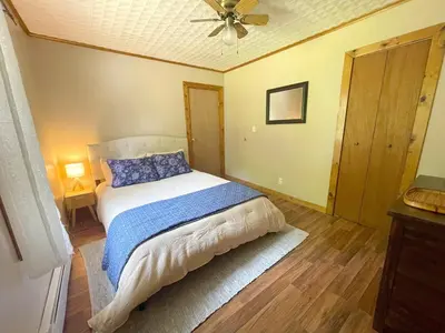 a bedroom with a bed and a ceiling fan at Cozy Creek House in Forestburgh