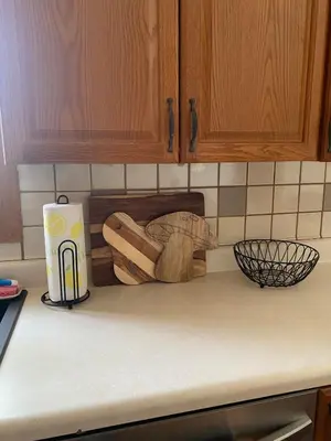 a kitchen counter with a cutting board on a counter top at Cozy Creek House in Forestburgh