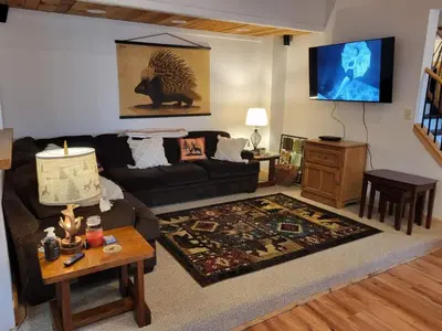 a living room with a couch and a table at Romantic Retreat with a Jacuzzi 