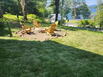 a group of chairs sitting in the grass at Romantic Retreat with a Jacuzzi 