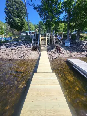 a wooden boardwalk leading to a playground in the water at Romantic Retreat with a Jacuzzi 