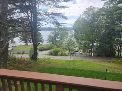 a balcony with a view of a street and a lake at Romantic Retreat with a Jacuzzi 
