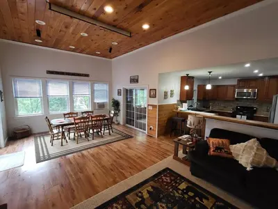 a living room with a table and chairs and a kitchen at Romantic Retreat with a Jacuzzi 