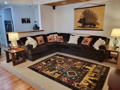 a living room with a couch and a rug at Romantic Retreat with a Jacuzzi 