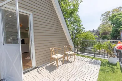 a patio with two chairs on the side of a house at Zen Den With King Bed and Very Close to Airport in Newark