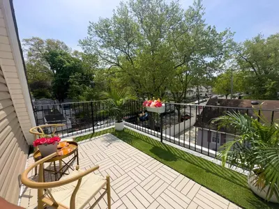 a balcony with a fence and a table and chairs at Zen Den With King Bed and Very Close to Airport in Newark