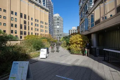 two people walking down a sidewalk in a city at Blueground Chelsea fitness center nr Madison Square Park NYC-390 in New York