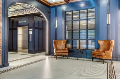 two chairs in a hallway with blue walls at Blueground Williamsburg rooftop nr East River NYC-1942 in Brooklyn