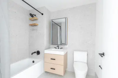 a bathroom with a sink and a toilet and a mirror at Blueground Southside doorman nr Brooklyn Bridge NYC-2132 in Brooklyn