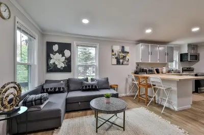 a living room with a couch and a kitchen at Group Getaway 1 Mile From Hunter Mtn with Fire Pit in Hunter