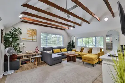 a living room with a couch and a table at Group Getaway 1 Mile From Hunter Mtn with Fire Pit in Hunter