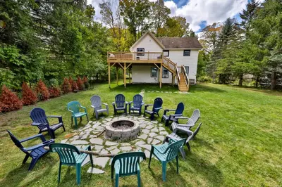 a group of chairs around a fire pit in a yard at Group Getaway 1 Mile From Hunter Mtn with Fire Pit in Hunter