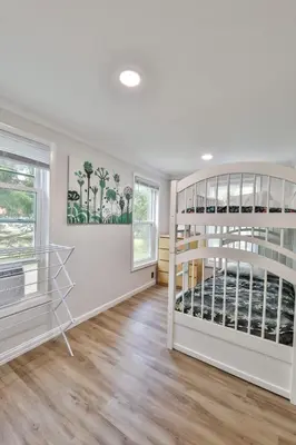 a white room with bunk beds and a window at Group Getaway 1 Mile From Hunter Mtn with Fire Pit in Hunter