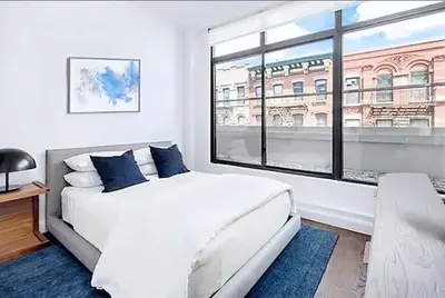 a bedroom with a white bed and a large window at Residence Heritage Terrace Dreaming in New York