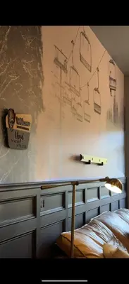 a bedroom with a bed and a table with a sign on the wall at Modern Hunter Mountain Condo Steps from Slopes in Hunter