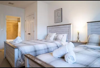 a bedroom with two beds and a window at Modern Hunter Mountain Condo Steps from Slopes in Hunter