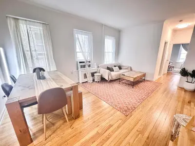 a living room with a table and a couch at Upper East Side 2Bed Dream in New York