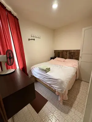 a small bedroom with a bed and a desk at Hudson Yard 4 in New York
