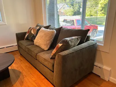 a couch with pillows on it in a living room at Litchfield Retreat, Wineries, Foliage & Skiing in Torrington