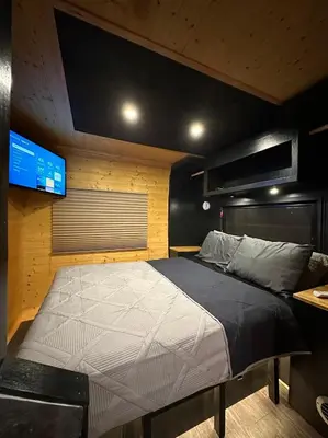 a large bed in a room with a television at Catskill and Chill in Catskill