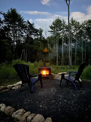 two chairs and a fire pit in a yard at Catskill and Chill in Catskill