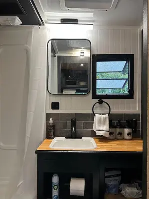 a bathroom with a sink and a window in an rv at Catskill and Chill in Catskill
