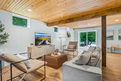a living room with white walls and wooden ceilings at The Homestead at Carter Bridge Estate in Freehold