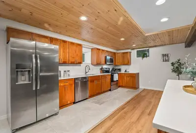 a kitchen with wooden cabinets and stainless steel appliances at The Homestead at Carter Bridge Estate in Freehold
