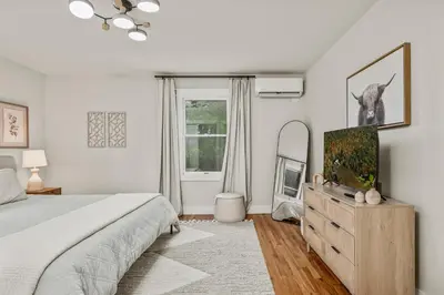 a bedroom with a bed and a television on a dresser at The Homestead at Carter Bridge Estate in Freehold