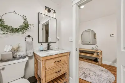 a bathroom with a sink and a toilet and a mirror at The Homestead at Carter Bridge Estate in Freehold