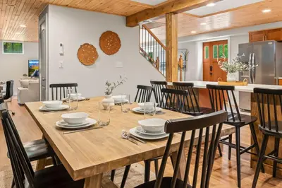 a kitchen and dining room with a wooden table and chairs at The Homestead at Carter Bridge Estate in Freehold