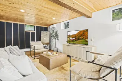 a living room with white furniture and a flat screen tv at The Homestead at Carter Bridge Estate in Freehold