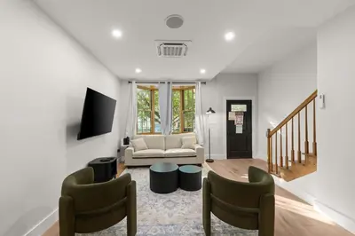 a living room with a couch and two chairs at 10-1 Stylish Townhouse Oasis in Greenpoint in Brooklyn