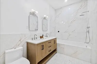 a bathroom with a toilet and a tub and a sink at 10-1 Stylish Townhouse Oasis in Greenpoint in Brooklyn
