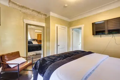a bedroom with a bed and a tv on the wall at Easy Commute to Newark and NYC! Extended Stay Unit in Irvington