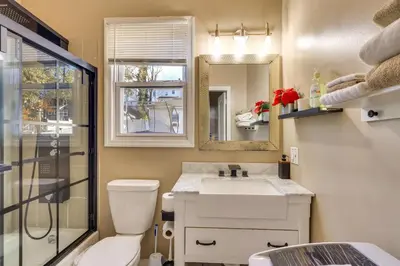a bathroom with a toilet and a sink and a mirror at Easy Commute to Newark and NYC! Extended Stay Unit in Irvington