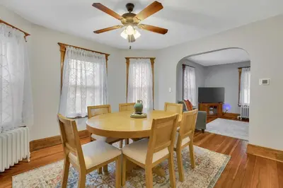 a dining room with a table and chairs and a ceiling fan at The Game House Arcade West Hartford in West Hartford