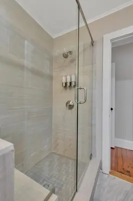 a shower with a glass door in a bathroom at The Game House Arcade West Hartford in West Hartford