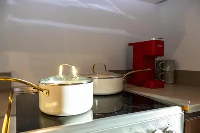 two pots and pans sitting on top of a kitchen counter at Lux Bronx Apt Rooftop, Pool, Gym, Cinema in Mott Haven