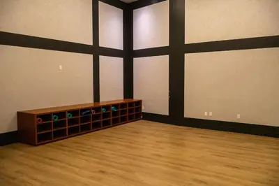 an empty room with a wooden floor and black and white walls at Lux Bronx Apt Rooftop, Pool, Gym, Cinema in Mott Haven