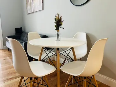 a white dining room table with white chairs at The Marlow Midtown in New York