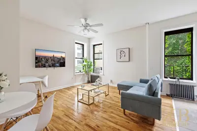 a living room with a couch and a table at Gorgeous 2 Bedroom Apt in UES in New York