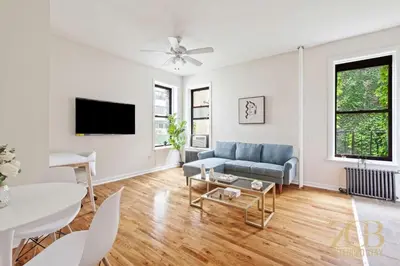 a living room with a couch and a tv at Gorgeous 2 Bedroom Apt in UES in New York