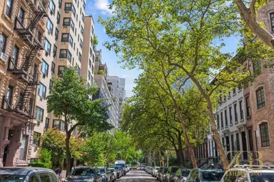 a city street with cars parked on the street at Gorgeous 2 Bedroom Apt in UES in New York