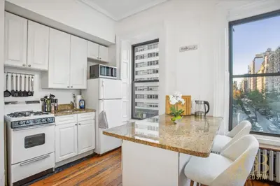 a kitchen with white appliances and a large window at Beautiful 1-Bedroom in the Upper East Side in New York