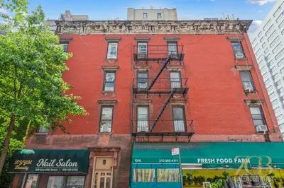 a red brick building on a city street at Beautiful 1-Bedroom in the Upper East Side in New York