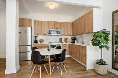 a kitchen with a table and chairs and a refrigerator at Beautiful and Spacious 2 Bed 2 Bath Apt - Elevator in New York