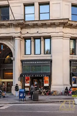 a building on a city street with a store at State-of-the-Art Loft-Style 2Br Apartment - Laundry - Chelsea in New York