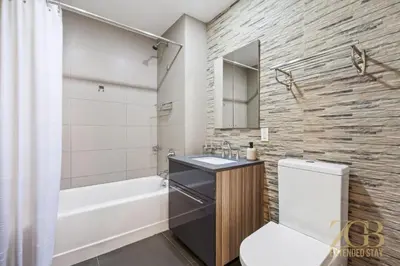 a bathroom with a sink and a tub and a toilet at Stylish 2-Bedroom Near Central Park - Laundry - Elevator in New York